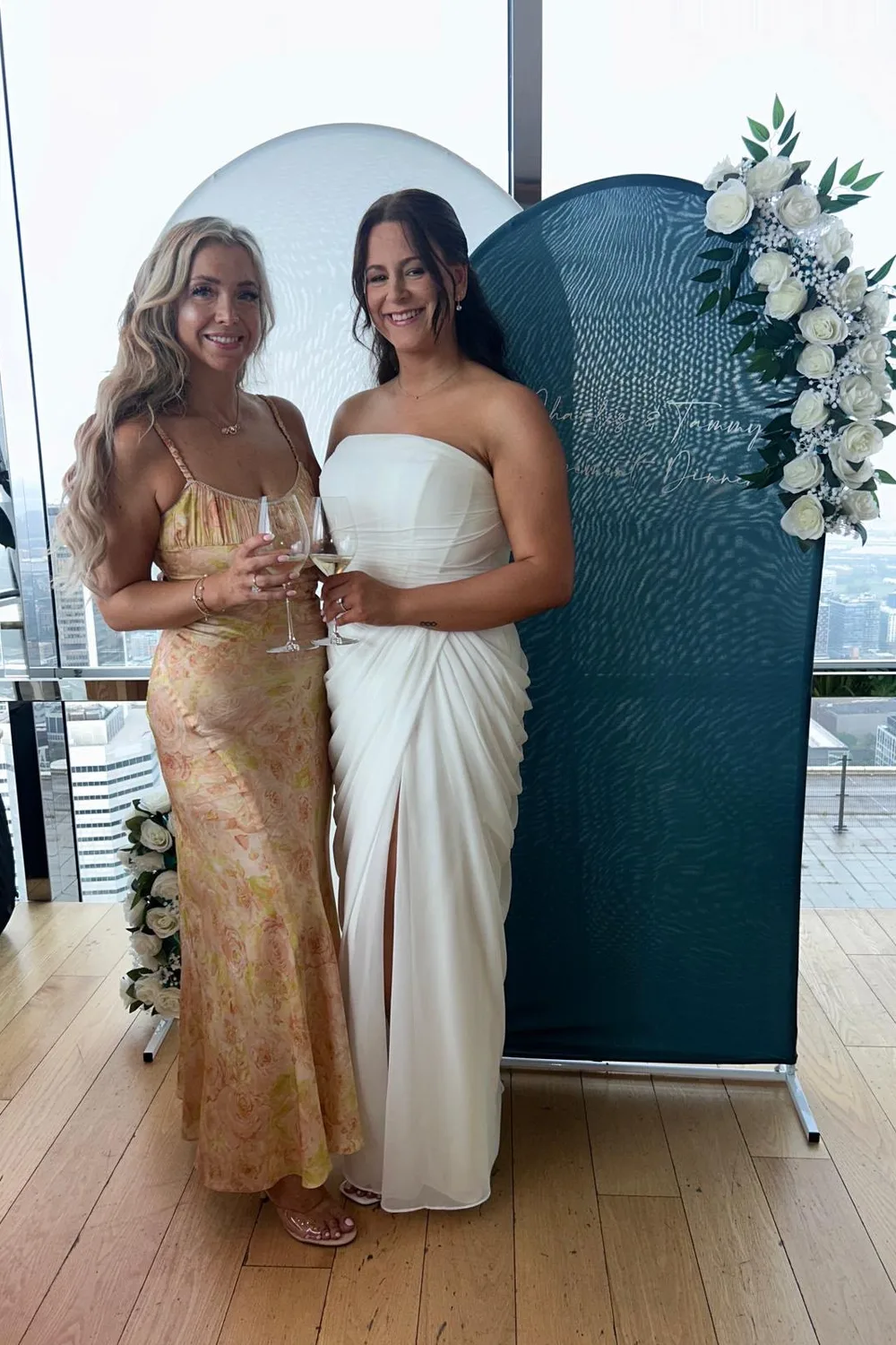 Two guests in long dresses at a bachelorette party, tanned by GLOW17