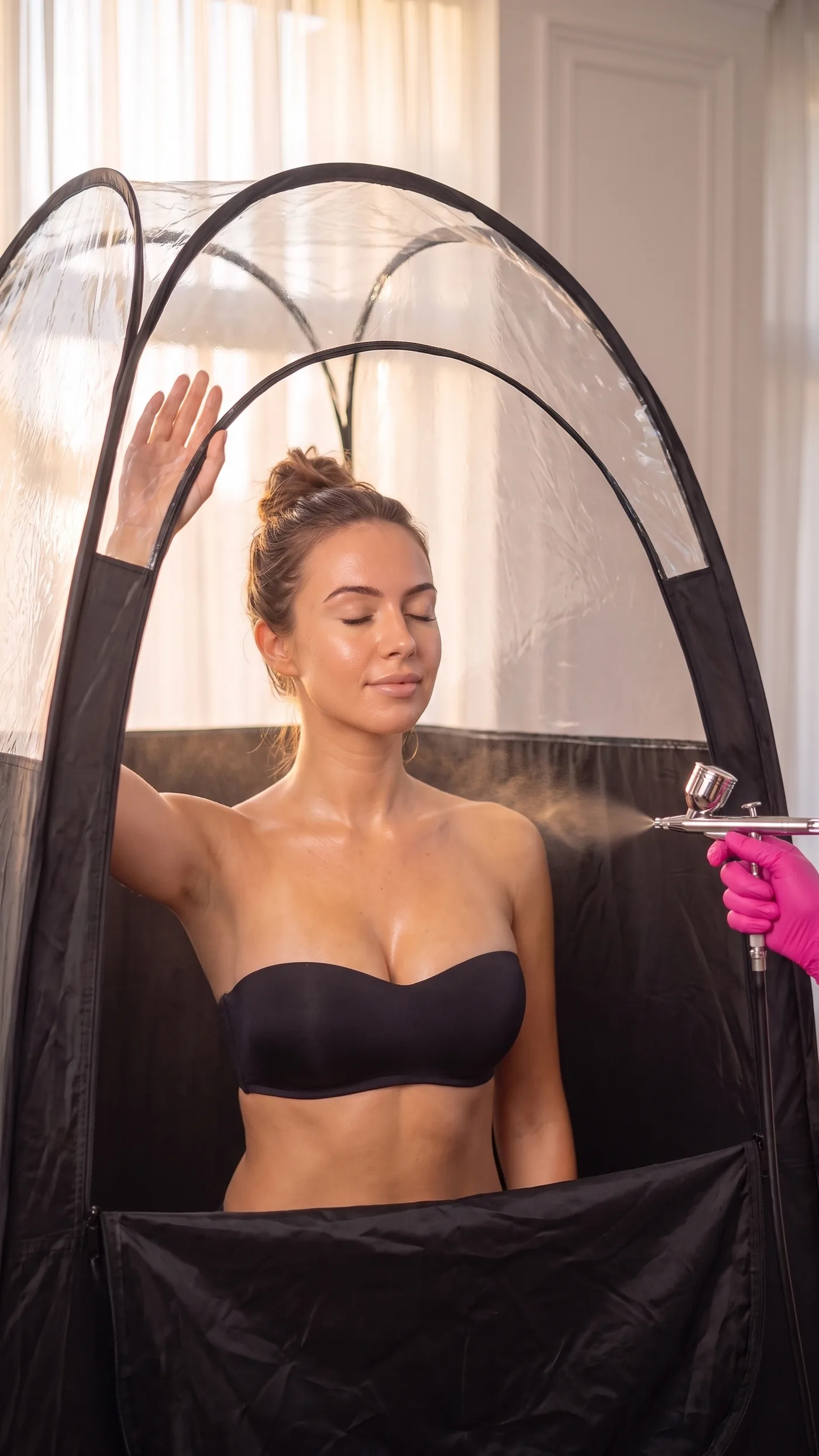 Relaxed client inside the GLOW17 tent, at-home spray tan in Saint-Eustache