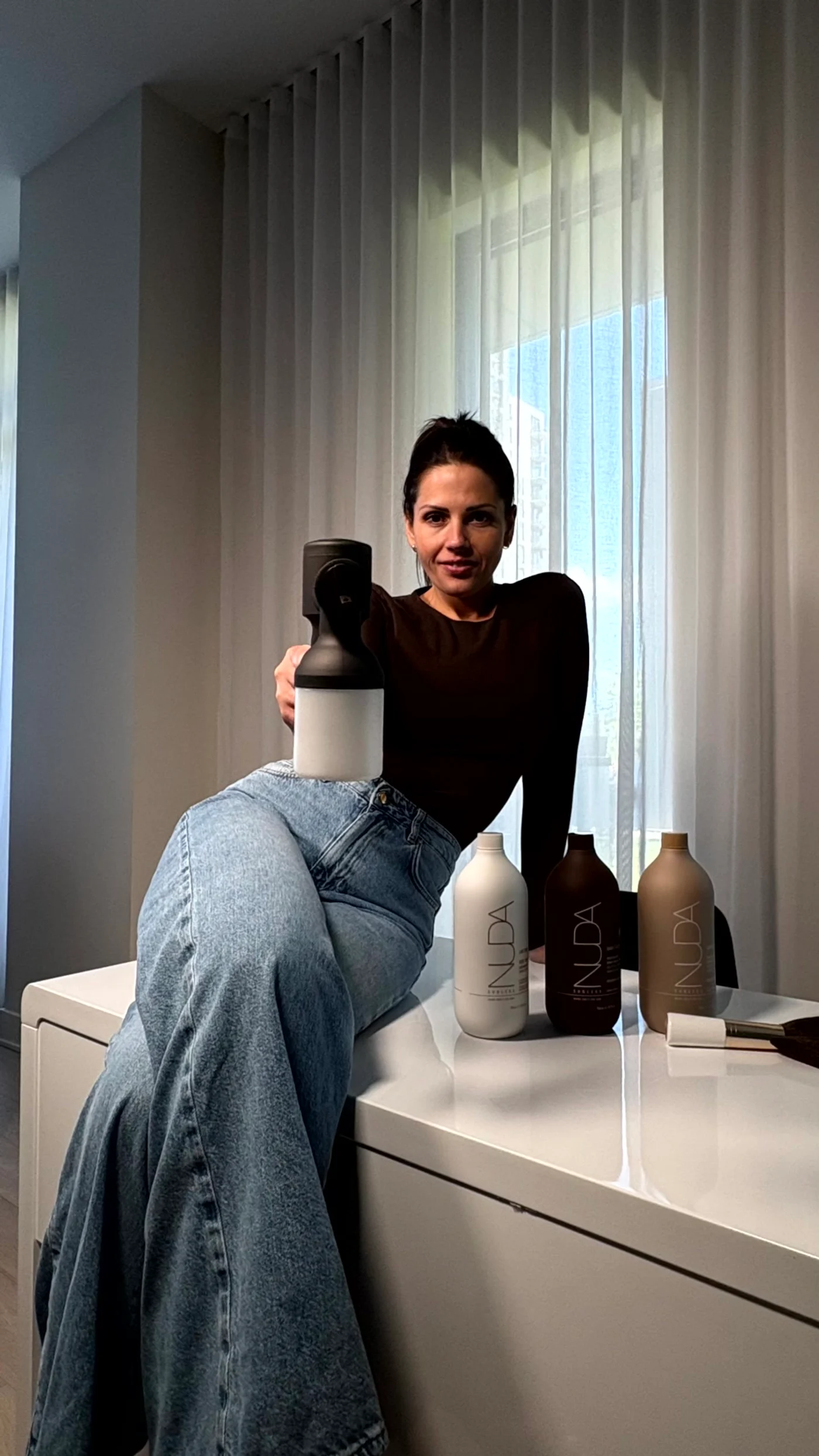 Ana Maria of GLOW17 with the NUDA bottles, mobile spray tan in Terrebonne